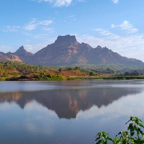 Mountains reflected in a calm lake near Mumbai